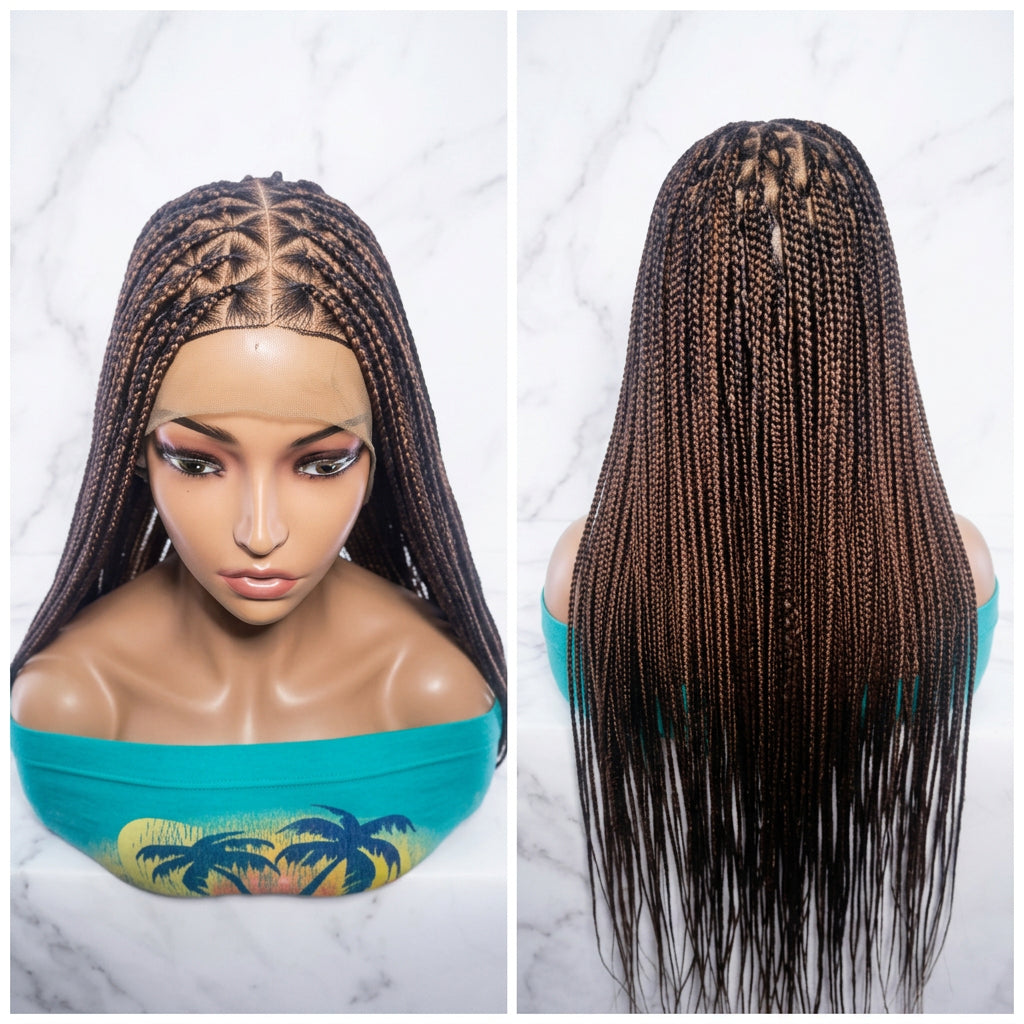The wig has dark brown roots and lighter brown to near-black box braids 