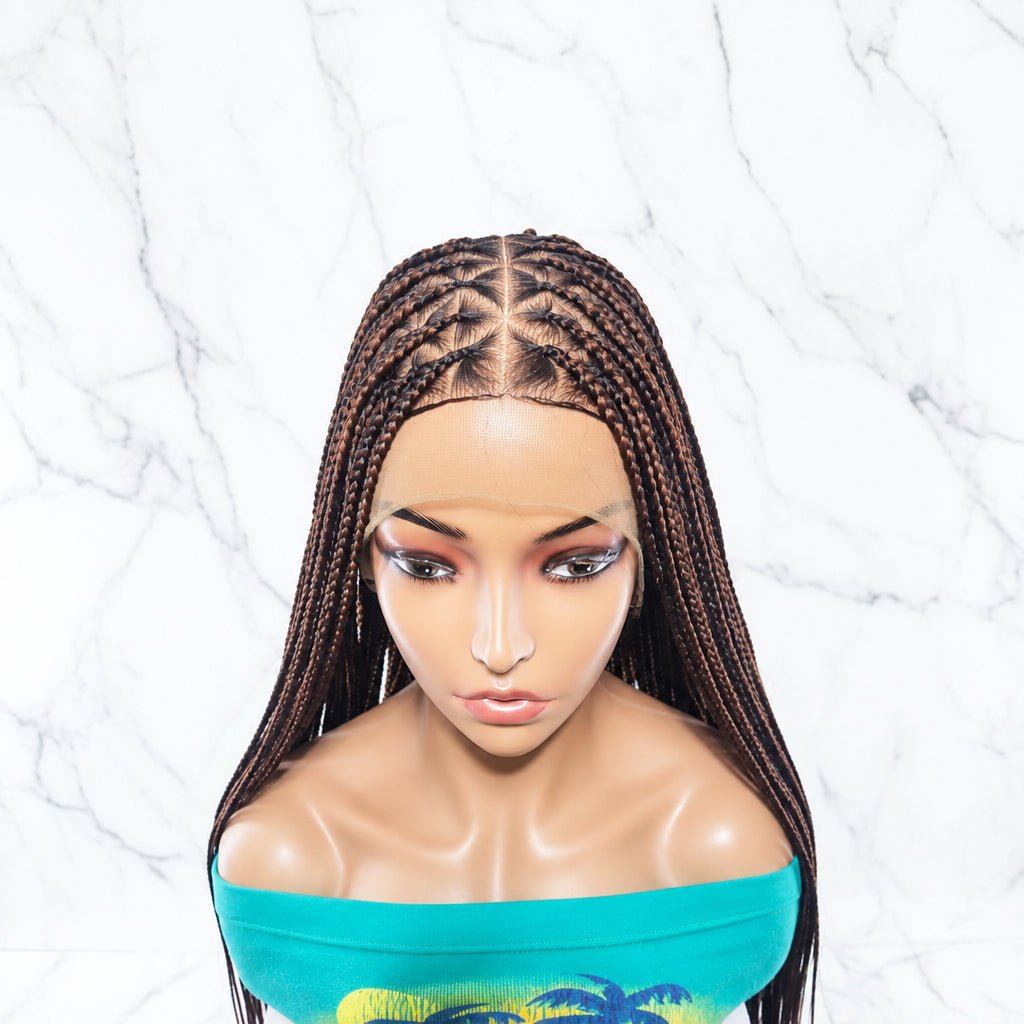 long braided wig with dark brown to black box braids, styled with a center part and long straight sections. 
