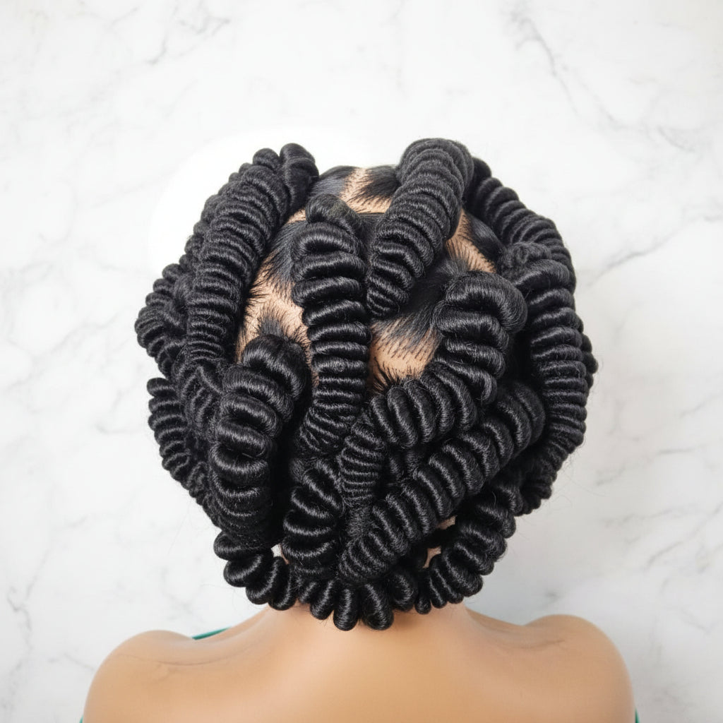 A close-up of a  black wig with tight, defined ringlets, puff strings braids
