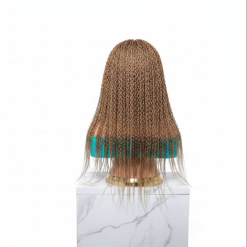 A textured, curly wig copper brown color. 