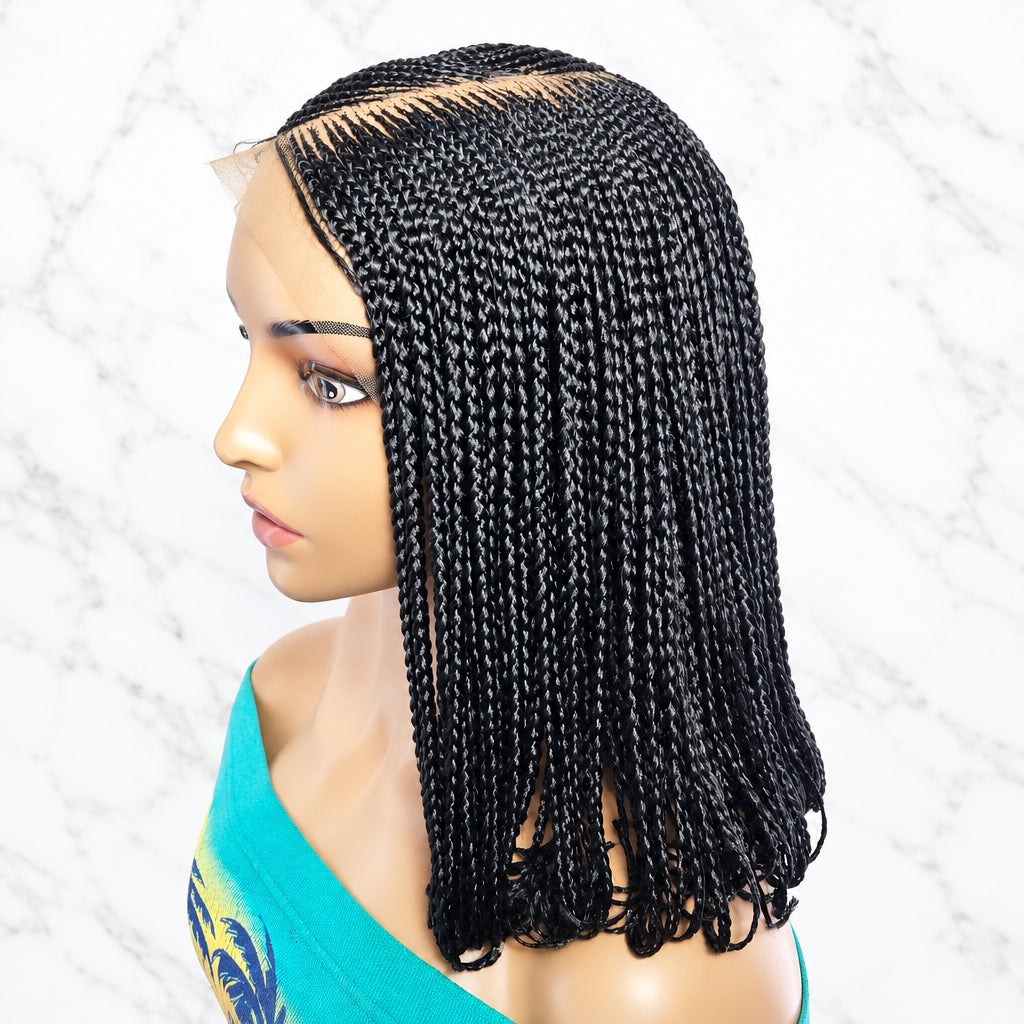 Black braided synthetic hair extensions styled on a mannequin head, showing a clean parting and long, tight cornrow-style braid texture against a plain light background.